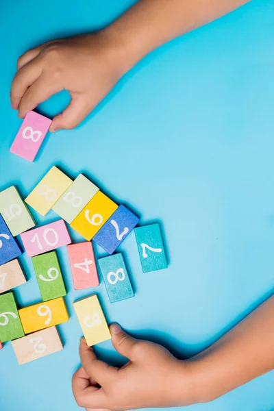 colored cubes with numbers hands