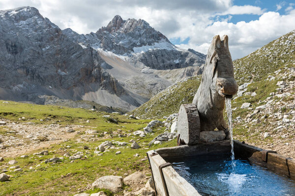 Water spring on Alps mountains background Dolomites