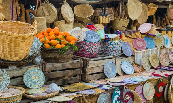 Craft wicker hats, bags, oranges and other souvenirs in Morocco market