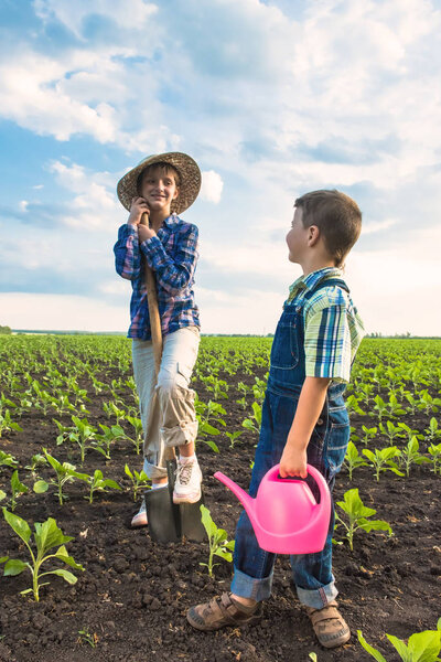 Happy small farmers in spring field