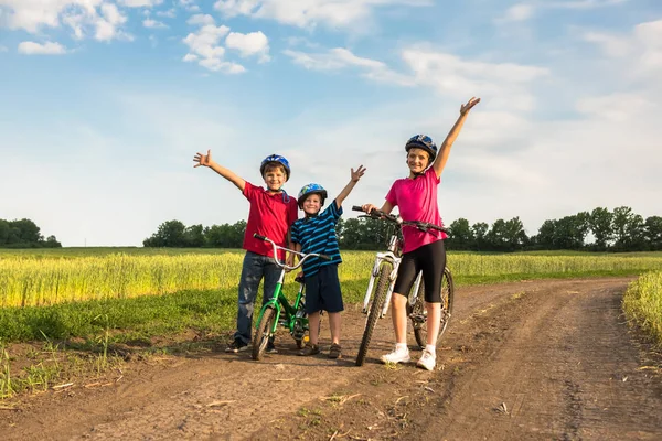 Sporty children in helmets with bikes — Stock Photo, Image