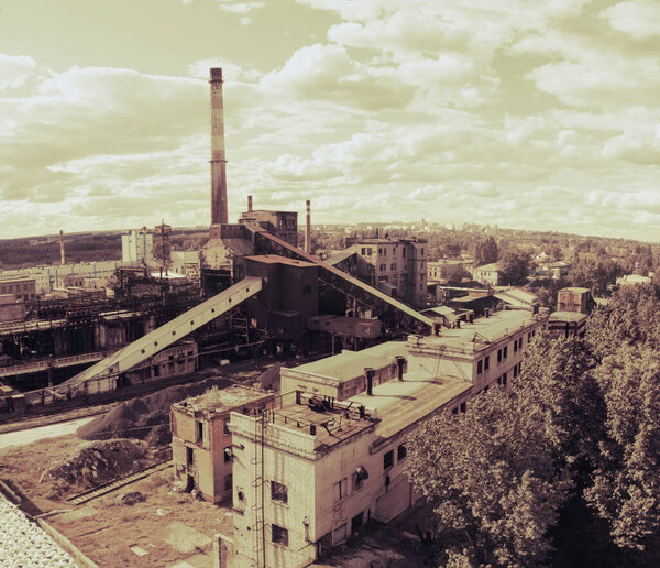 Aerial drone shot of old coke coal industrial zone with smoke stack. Air pollution concept.