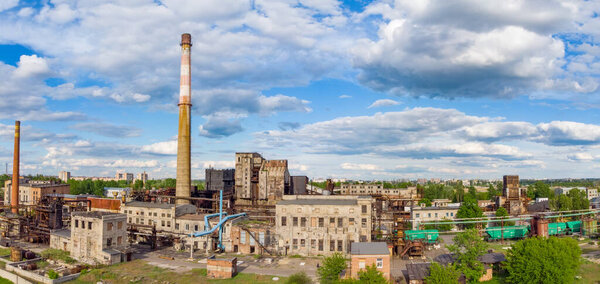 Aerial drone shot of old industrial zone with smoke stack. Air pollution concept