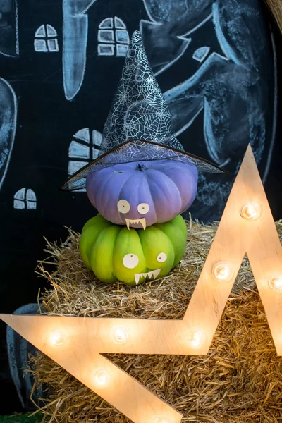 Halloween pumpkin head jack lantern on a Haystack.