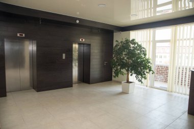 Two doors of elevators in modern business building clipart