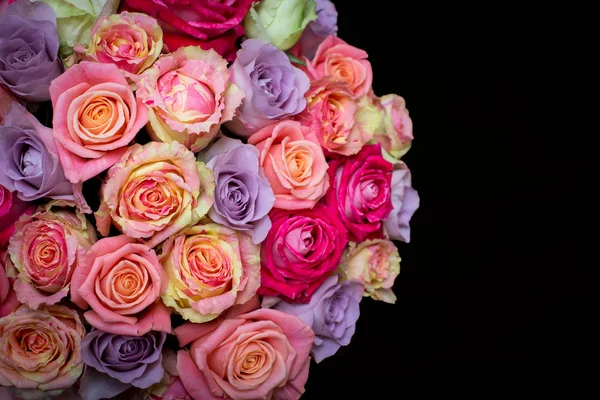 Beautiful bouquet of roses in a gift box. Bouquet of pink roses. Pink roses close-up. on black background, with space for text