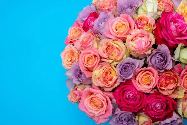 Beautiful bouquet of roses in a gift box. Bouquet of pink roses. Pink roses close-up. on blue background, with space for text