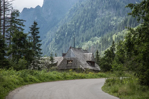 Road in mountains near house. Path leading to mountain lake. Tatras, Poland