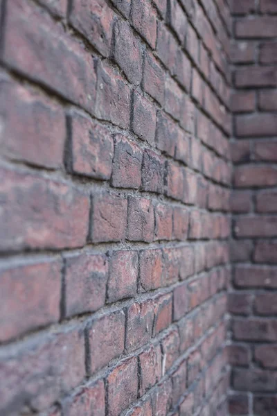 Old wall of dark red brick. Stone wall background