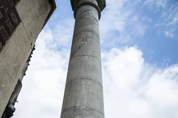 Concrete column against the sky. Column going upwards