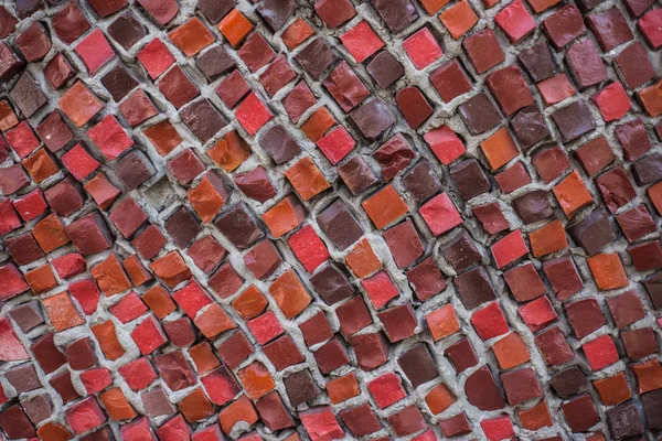 Red wall from mosaic. Background of red color mosaic close-up