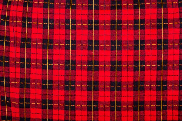 Fabric black and red checkered background. Texture of checkered fabric close-up