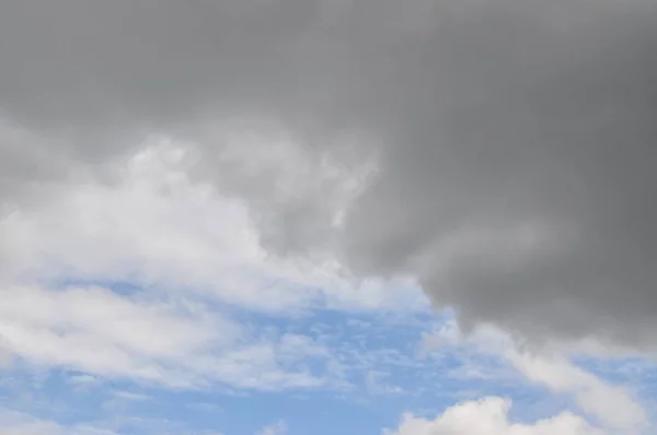 Beautiful blue sky with clouds background. Blue Sky with Stormy Cumulus Clouds