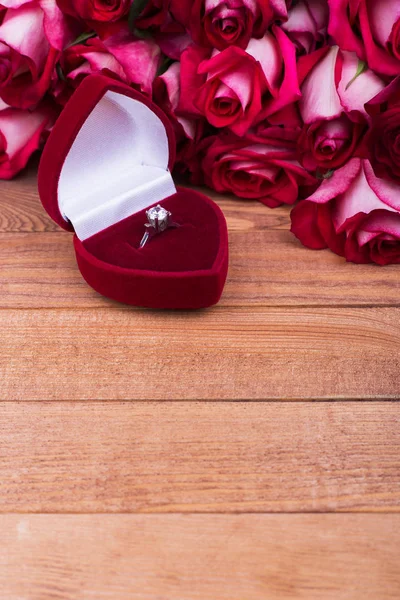 Beautiful box with jewels and flowers. Roses and red gift box with ring