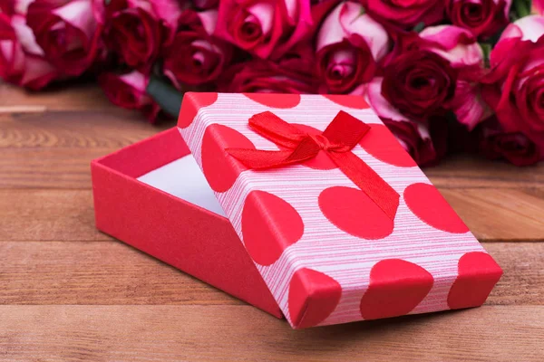 Red box with bow, roses. Beautiful roses and gift box