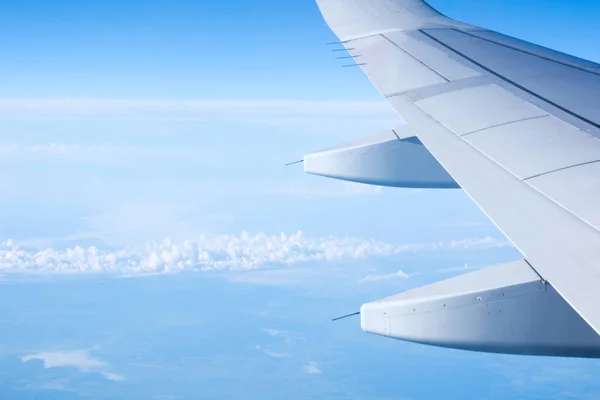 Aircraft wing on the clouds, flying background