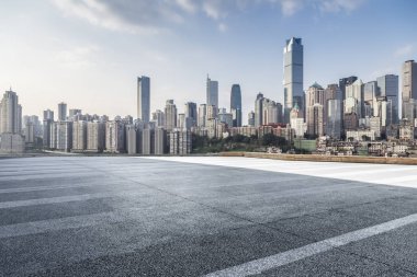 Panoramik siluet ve boş yolu, boş beton zemini olan modern iş binaları.