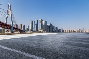 Panoramik siluet ve boş yolu, boş beton zemini olan modern iş binaları.