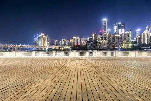 Panoramik siluet ve boş yolu, boş beton zemini olan modern iş binaları.