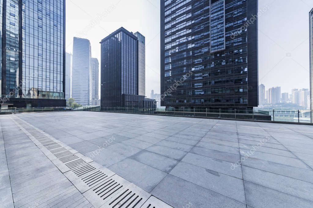 Panoramic skyline and modern business office buildings with empty road,empty concrete square floor