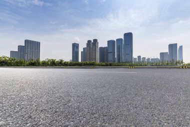 Panoramik siluet ve boş yolu, boş beton zemini olan modern iş binaları.