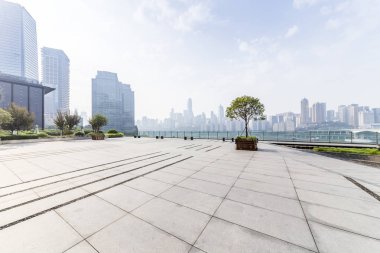 Panoramik siluet ve boş yolu, boş beton zemini olan modern iş binaları.