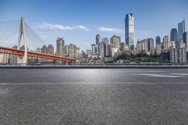 Panoramik siluet ve boş yolu, boş beton zemini olan modern iş binaları.