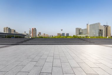 Panoramik siluet ve boş yolu, boş beton zemini olan modern iş binaları.