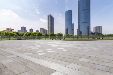 Panoramik siluet ve boş yolu, boş beton zemini olan modern iş binaları.