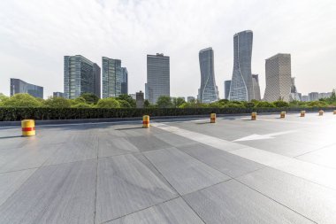 Panoramik siluet ve boş yolu, boş beton zemini olan modern iş binaları.