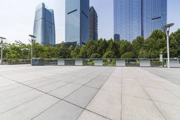 Panoramik siluet ve boş yolu, boş beton zemini olan modern iş binaları.