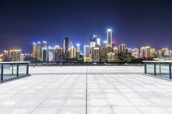 Panoramic skyline and buildings with empty road at night