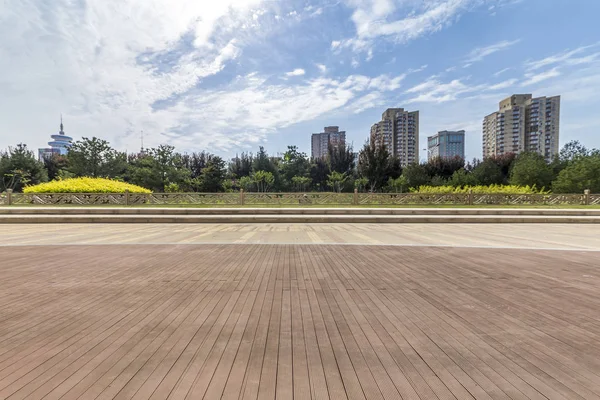 Panoramik siluet ve boş yolu, boş beton zemini olan modern iş binaları.