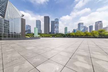 Panoramik siluet ve boş yolu, boş beton zemini olan modern iş binaları.