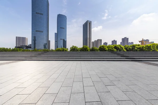 Panoramik siluet ve boş yolu, boş beton zemini olan modern iş binaları.