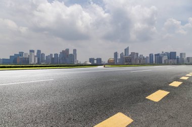 Panoramik siluet ve boş yolu, boş beton zemini olan modern iş binaları.