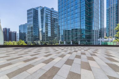 Panoramik siluet ve boş yolu, boş beton zemini olan modern iş binaları.