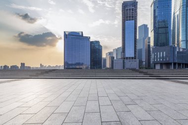 Panoramik siluet ve boş yolu, boş beton zemini olan modern iş binaları.