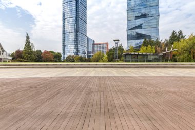 Panoramik siluet ve boş yolu, boş beton zemini olan modern iş binaları.