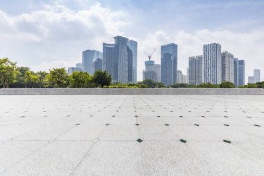 Panoramik siluet ve boş yolu, boş beton zemini olan modern iş binaları.