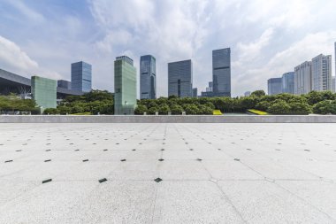 Panoramik siluet ve boş yolu, boş beton zemini olan modern iş binaları.