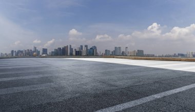 Panoramik siluet ve boş yolu, boş beton zemini olan modern iş binaları.