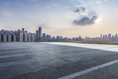Panoramik siluet ve boş yolu, boş beton zemini olan modern iş binaları.
