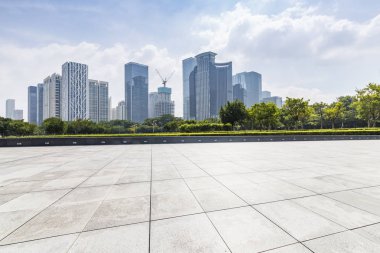 Panoramik siluet ve boş yolu, boş beton zemini olan modern iş binaları.