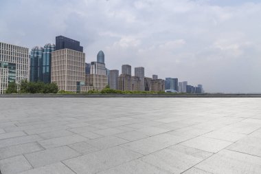Panoramik siluet ve boş yolu, boş beton zemini olan modern iş binaları.