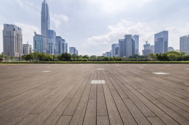 Panoramik siluet ve boş yolu, boş beton zemini olan modern iş binaları.