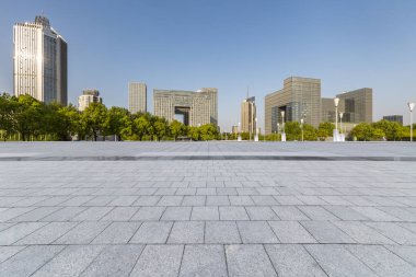 Panoramik siluet ve boş yolu, boş beton zemini olan modern iş binaları.
