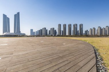 Panoramik siluet ve boş yolu, boş beton zemini olan modern iş binaları.