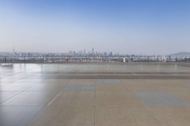 Panoramik siluet ve boş yolu, boş beton zemini olan modern iş binaları.