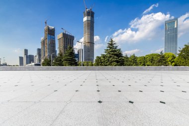 Panoramik siluet ve boş yolu, boş beton zemini olan modern iş binaları.